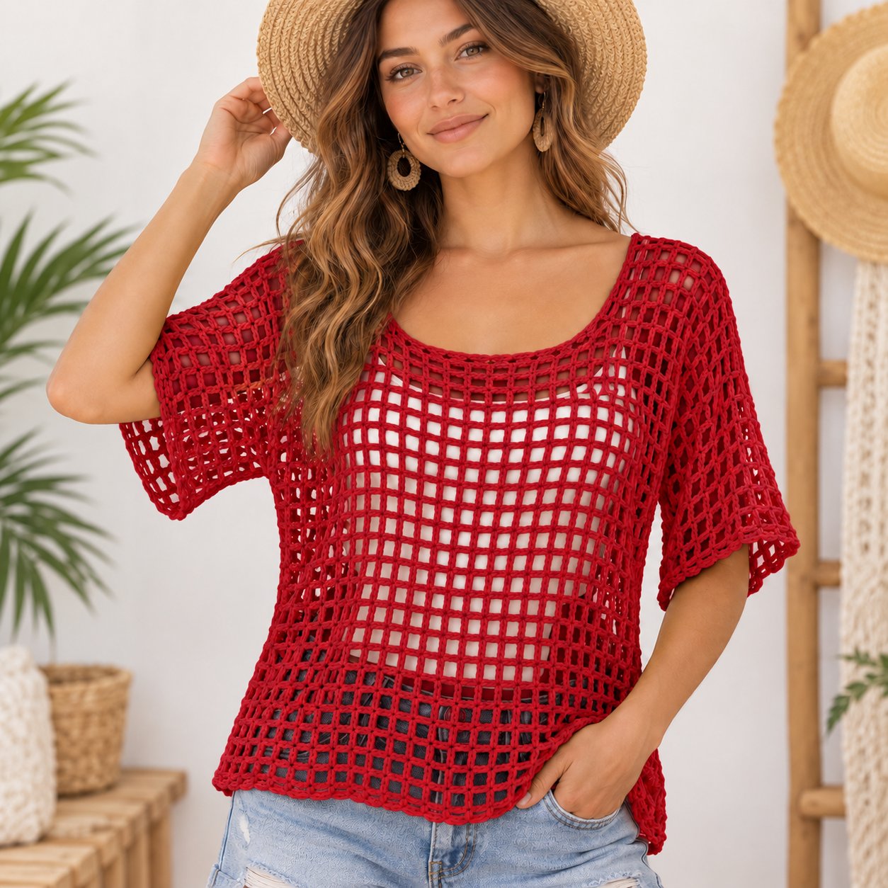 Model wearing a relaxed red crochet mesh top over a white camisole